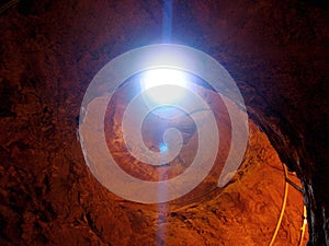 Light Beam Into the Canyon,Rays of light illuminating red sandstone cave.