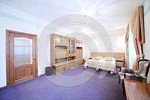 Light bedroom with a double bed and wall