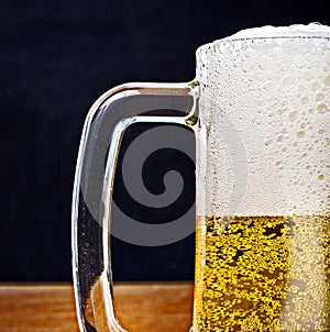 Light Beer in a glass pint mug served on a wooden