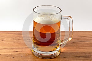 Light beer mug against the backdrop of the bar shelf