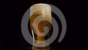 Light beer is pouring into glass. IPA. Cold Light Beer in a glass with water drops. Craft Beer forming foam close up