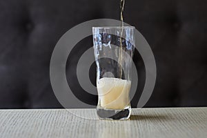 Light beer pouring in glass