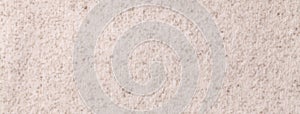 Light beige fluffy background, fleecy cloth. Texture of cream color wool textile backdrop