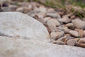 Light beige sandstone rock and pebbles side view background texture