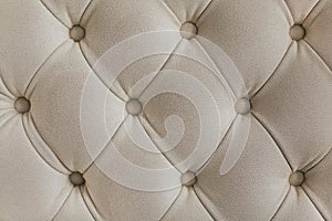 Light beige velour textile diamond pattern with buttons. Background concept. Furniture sofa cover