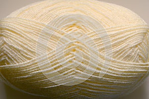 Light beige woolen threads in a skein for knitting close-up