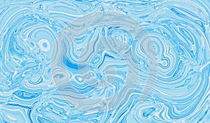 Light blue abstract liquid paint textured background with decorative spirals and swirls photo