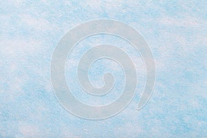 Light blue background of felt fabric. Texture of woolen textile