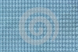 Light blue background from soft fleecy fabric close up. Texture of textiles macro