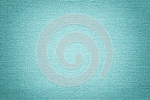 Light blue background from a textile material. Fabric with natural texture. Backdrop