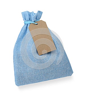 Light blue burlap bag with tag isolated on white, top view