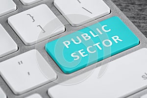 Light blue button with text Public Sector on computer keyboard, closeup