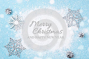 Light blue Christmas and New Year card of snow and silver snowfl