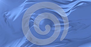 Light blue cloth or silk flag waving at wind in slow, loop