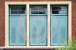 Light blue combination windows on brick wall