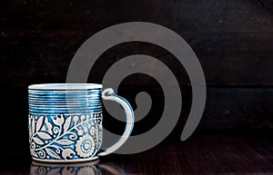 Light blue cup on old wooden dark background