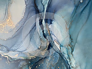 Light blue and dark blue abstract backgroud made with alcohol ink and gold pigment