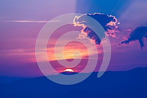 Beautiful colorful sunset with dramatic clouds and sun shining