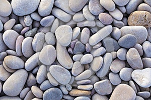 Light blue and garnet smooth rocks in natural landscape