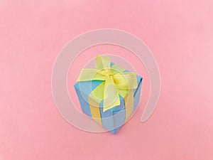 Light blue gift box on pink background.