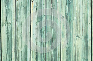 Light blue-green weathered wooden fence