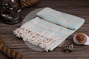 Light Blue Handwoven hammam Turkish cotton towel on rustic wooden background