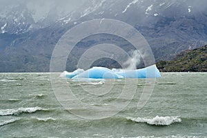 Light blue iceberg on lake Grey at Torres del Paine national park in southern Chile.