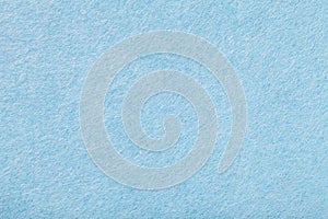 Light blue matt suede fabric closeup. Velvet texture of felt