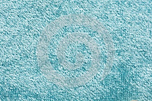 Light blue matte background of suede fabric, closeup. Velvet texture of seamless denim textile, macro. Structure of sky