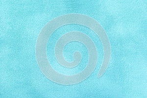 Light blue matte background of suede fabric, closeup. Velvet texture of textile