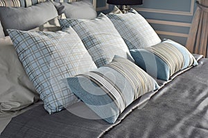 Light blue pillows in difference pattern with classic bedding