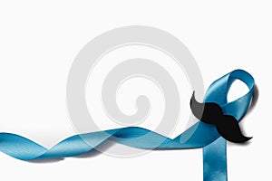 Light blue ribbon with mustache on white background. Prostate Cancer Awareness, Movember Men`s health awareness. Healthcare