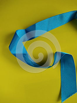 Light blue ribon isolated on yellow background