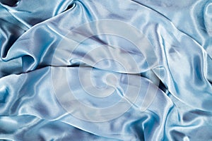 Light blue satin background and texture. Grooved of blue fabric abstract. Top view with empty space.