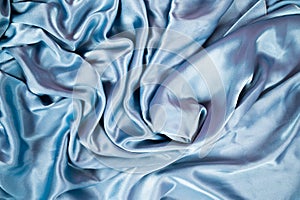 Light blue satin background and texture. Grooved of blue fabric abstract. Top view with empty space.