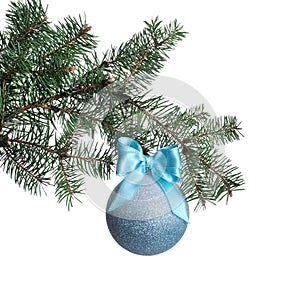Light blue shiny Christmas ball on fir branch against white background