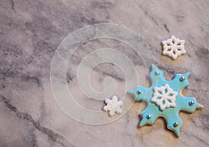 Light Blue Snowflake Cookie on Gray and White Marble Background