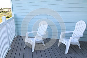 light blue terrace and white chairs.