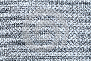 Light blue textile background with checkered pattern, closeup. Structure of the fabric macro.