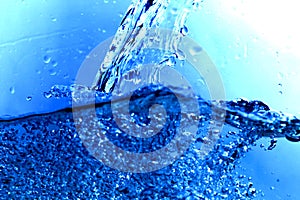 light blue transparent water wave surface with splash bubble on blue