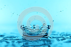 light blue transparent water wave surface with splash bubble on blue