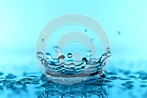 light blue transparent water wave surface with splash bubble on blue