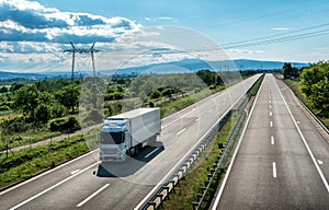 Light Blue Transportation Truck on a Highway Road