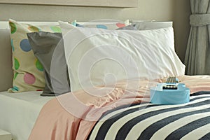 Light blue ukulele on striped bedding