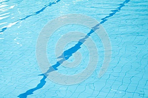 Light blue water with wave and ripple in swimming pool background