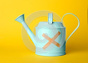 Light blue watering can with sticking plasters photo