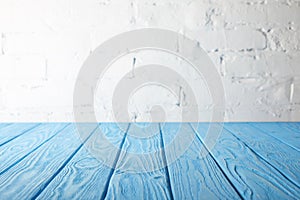 light blue wooden tabletop and white wall
