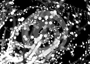 Light bokeh blur with black and white glow. Circular shiny pattern with glitter, sparkle and