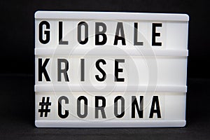 A light box with the inscription: GLOBALE  #CORONA with white background photo