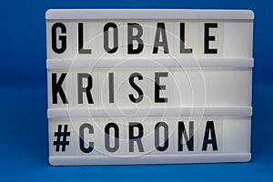 A light box with the inscription: GLOBALE  #CORONA photo